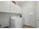 Functional laundry room with modern appliances and ample storage cabinets at 40265 N Acadia Ct, Anthem, AZ 85086