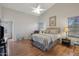 Cozy main bedroom showcasing neutral tones, a ceiling fan, and an attached en-suite bathroom at 40265 N Acadia Ct, Anthem, AZ 85086