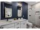 Elegant bathroom with a dual vanity, a glass-enclosed shower, and contemporary design elements at 4119 E Indianola Ave, Phoenix, AZ 85018