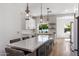 Modern kitchen featuring a large center island with ample counter space and stylish pendant lighting at 4119 E Indianola Ave, Phoenix, AZ 85018