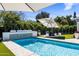 Sparkling swimming pool with a modern water feature and relaxing outdoor dining area, great for entertaining at 4119 E Indianola Ave, Phoenix, AZ 85018