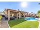 Expansive backyard featuring a pristine pool, lush turf, and covered patio ideal for outdoor entertaining at 4502 E Meadow Dr, Phoenix, AZ 85032