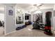 Home gym featuring mirrored wall, a ceiling fan, exercise equipment, and natural light from an arched window at 4502 E Meadow Dr, Phoenix, AZ 85032