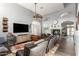 Bright living room with fireplace, beamed ceiling fan, modern furnishings and an open floor plan to the entrance hall at 4502 E Meadow Dr, Phoenix, AZ 85032