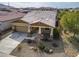 Aerial of a tan single-Gathering home with a two-car garage and a desert-style landscaped front yard in a residential community at 4708 S 117Th Ave, Avondale, AZ 85323