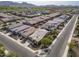 Beautiful aerial view of homes in a suburban neighborhood with lush green fields and mountains in the distance at 4708 S 117Th Ave, Avondale, AZ 85323