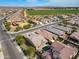 An aerial view of a neighborhood featuring a green field and playground across the street at 4708 S 117Th Ave, Avondale, AZ 85323