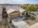 Beautiful aerial view of a tan single-Gathering home with a landscaped front yard and spacious driveway in a suburban neighborhood at 4708 S 117Th Ave, Avondale, AZ 85323