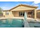 Lovely backyard featuring a pool, covered patio, and sliding glass doors that bring the outdoors in for year-round enjoyment at 4708 S 117Th Ave, Avondale, AZ 85323