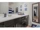 Bathroom features a white countertop, dark cabinets, and a large mirror at 4708 S 117Th Ave, Avondale, AZ 85323