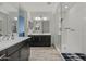 Modern bathroom features dual sink vanity, framed mirrors, and a glass-enclosed shower at 4708 S 117Th Ave, Avondale, AZ 85323