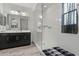 Bright bathroom showcasing glass enclosed shower, dark cabinets, and modern fixtures at 4708 S 117Th Ave, Avondale, AZ 85323