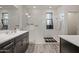 Well-lit bathroom with a glass shower, dual vanity, and dark gray shaker cabinets at 4708 S 117Th Ave, Avondale, AZ 85323