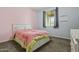 Cozy bedroom with neutral carpet, a pink accent wall, and a bright window with curtains at 4708 S 117Th Ave, Avondale, AZ 85323