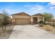 Single-story home boasts a well-maintained front yard, desert landscaping, and attached two-car garage at 4708 S 117Th Ave, Avondale, AZ 85323