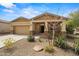 Single-story home featuring desert landscaping, covered entry, and an attached two-car garage at 4708 S 117Th Ave, Avondale, AZ 85323