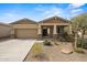 Inviting single-story home with desert landscaping, a covered porch, and a two-car attached garage at 4708 S 117Th Ave, Avondale, AZ 85323