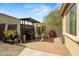 Private outdoor grilling area with lush greenery, pavers, and a built-in grill, perfect for summer barbecues at 4708 S 117Th Ave, Avondale, AZ 85323