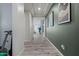 Hallway decorated with decorative art, beautiful flooring and modern lighting at 4708 S 117Th Ave, Avondale, AZ 85323