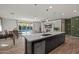 Open-concept kitchen island with quartz countertop that flows into the living area and out to the pool at 4708 S 117Th Ave, Avondale, AZ 85323