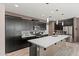 Contemporary kitchen with a large island and sleek black cabinets at 4708 S 117Th Ave, Avondale, AZ 85323