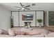 Cozy living room features a ceiling fan, wall mounted TV, and indoor plants at 4708 S 117Th Ave, Avondale, AZ 85323