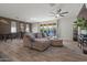 Open concept living room with modern finishes including backyard views, stylish flooring and comfortable seating at 4708 S 117Th Ave, Avondale, AZ 85323