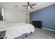 Inviting bedroom featuring plush carpeting, a ceiling fan, and a large window at 4708 S 117Th Ave, Avondale, AZ 85323