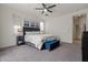 Bright and airy bedroom featuring plush carpeting, a ceiling fan, and large windows at 4708 S 117Th Ave, Avondale, AZ 85323