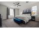 Bright, spacious bedroom featuring a ceiling fan and large windows at 4708 S 117Th Ave, Avondale, AZ 85323