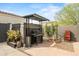 Inviting backyard with grill area, lush landscaping, and stylish pavers, perfect for outdoor cooking and entertaining at 4708 S 117Th Ave, Avondale, AZ 85323