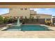 Resort-style pool with spa, travertine tile, and lush landscaping with a covered patio at 4708 S 117Th Ave, Avondale, AZ 85323