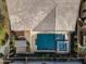 Aerial view of a private pool and hot tub with travertine tile decking and a covered patio area at 4708 S 117Th Ave, Avondale, AZ 85323