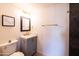 Stylish bathroom with a vanity, framed mirror, and dark marble tiled shower wall at 5106 N 17Th Ave # 3, Phoenix, AZ 85015