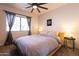 Cozy bedroom featuring a ceiling fan, and a comfortable bed with striped duvet at 5106 N 17Th Ave # 3, Phoenix, AZ 85015