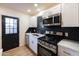 Modern kitchen with stainless steel appliances, black backsplash, and bright white cabinetry at 5106 N 17Th Ave # 3, Phoenix, AZ 85015