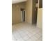 Spacious living room features tile flooring, neutral paint and an open doorway, with abundant natural light at 5114 W Joan De Arc Ave, Glendale, AZ 85304