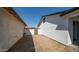 A view of the back yard with a wall, fencing, and a gate at 5327 W Saint Moritz Ln, Glendale, AZ 85306