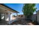 Backyard view with a covered patio, storage shed, and a tree at 5327 W Saint Moritz Ln, Glendale, AZ 85306