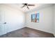 Bright bedroom featuring a ceiling fan, wood-look flooring, and a window that offers natural light at 5327 W Saint Moritz Ln, Glendale, AZ 85306