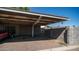 Spacious carport with overhead metal roof and storage area, offering ample parking at 5327 W Saint Moritz Ln, Glendale, AZ 85306