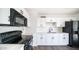 Bright kitchen with white shaker cabinets, solid surface counters and black appliances at 5327 W Saint Moritz Ln, Glendale, AZ 85306