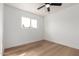 Bright bedroom featuring a ceiling fan, wood floors and a window with a neighborhood view at 556 E Manor Dr, Casa Grande, AZ 85122