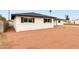 A bright single-story home with a xeriscaped yard and fresh white paint at 556 E Manor Dr, Casa Grande, AZ 85122