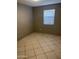 Bedroom features a large window and tile flooring at 6617 W Peck Dr, Glendale, AZ 85301