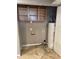 Functional utility room with shelving and water heater. Ready for your personal touch! at 6617 W Peck Dr, Glendale, AZ 85301