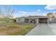 Charming single-story home with well-manicured lawn, covered front porch, and attached carport at 6704 N 10Th Pl, Phoenix, AZ 85014