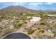 Desert home with an expansive driveway and lush desert landscaping on a sprawling lot at 7211 E Rising Star Way, Carefree, AZ 85377