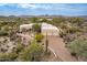 Desert property with a circular driveway, mature trees, and low-maintenance desert landscaping at 7211 E Rising Star Way, Carefree, AZ 85377