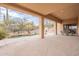 Covered patio with stone flooring, fireplace, and a view of the pool and desert landscaping at 7211 E Rising Star Way, Carefree, AZ 85377